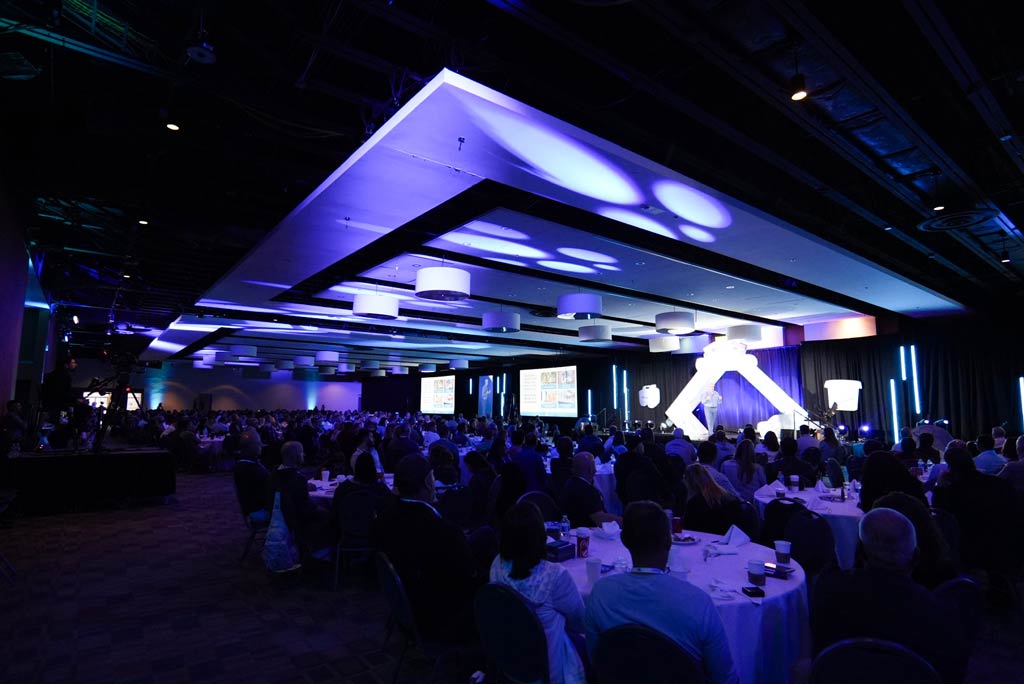 Conference delegates networking inside the MACC East Hall exhibit area