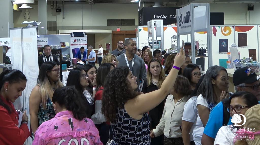 Attendees moving through the Miami Airport Convention Center (MACC) East Hall during a convention