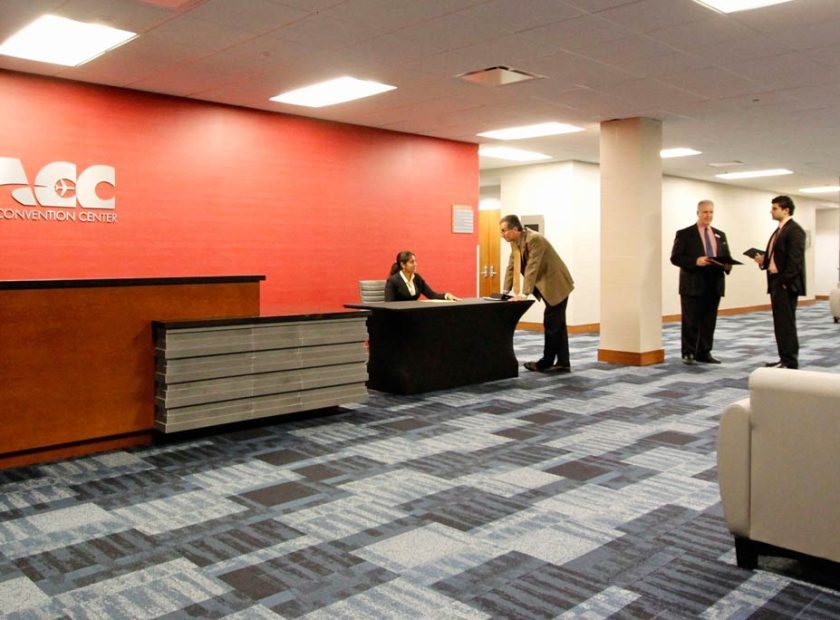 Business attendees checking in at the Miami Airport Convention Center (MACC) reception desk near MIA