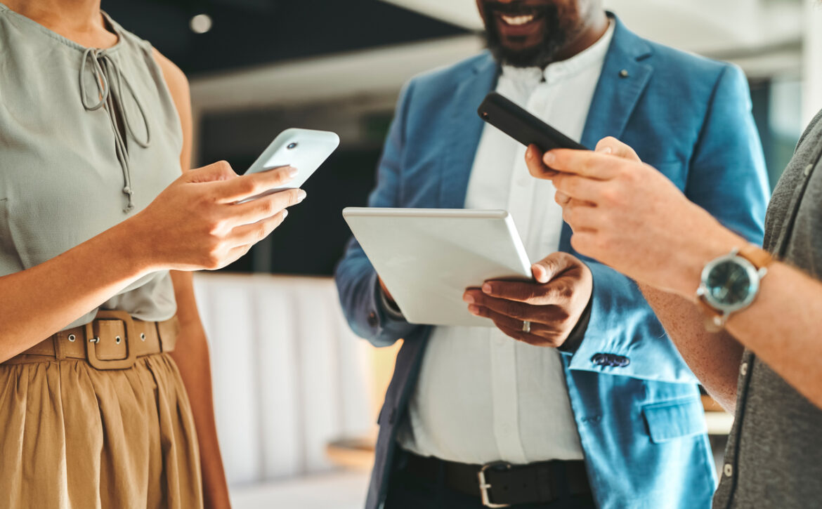 Diversity in working team using internet on phones and digital tablet for teamwork growth in the office. Professional staff work with 5g technology to match work schedule online the company website