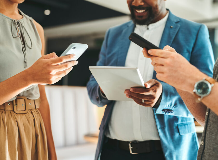 Diversity in working team using internet on phones and digital tablet for teamwork growth in the office. Professional staff work with 5g technology to match work schedule online the company website